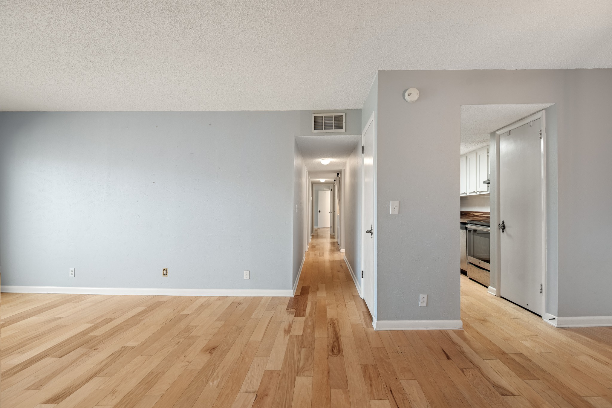 21 Vaughns Gap Road, Unit 23 Nashville, TN 37205 - Photo 6 of 25 an empty room with wooden floor and windows