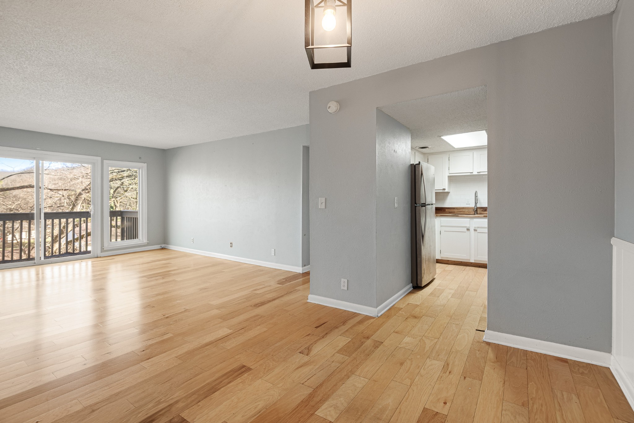 21 Vaughns Gap Road, Unit 23 Nashville, TN 37205 - Photo 9 of 25 wooden floor in an empty room with a window