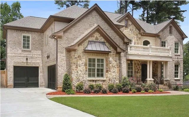 a front view of a house with a garden