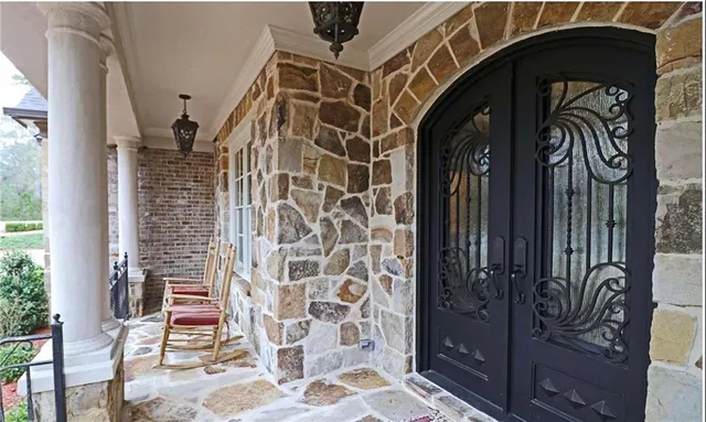 a living room with couches a coffee table and kitchen view with wooden floor
