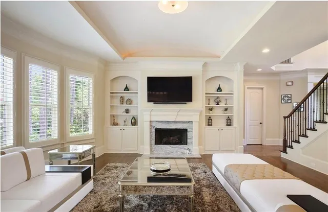 a kitchen with stainless steel appliances granite countertop a stove a sink and white cabinets