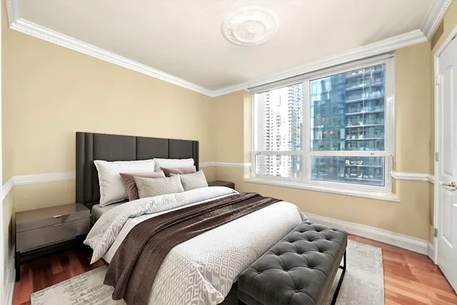 a bedroom with a bed and a large window