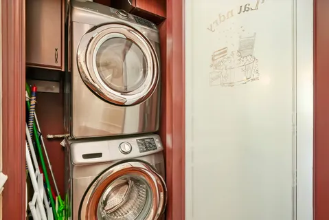 a view of a storage & utility room with dryer and washer