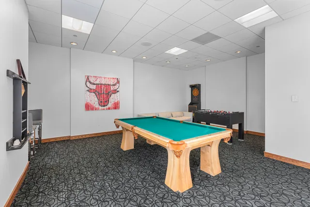 a room with pool table and windows