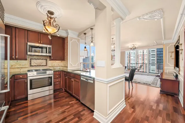 a kitchen with stainless steel appliances granite countertop a stove and cabinets