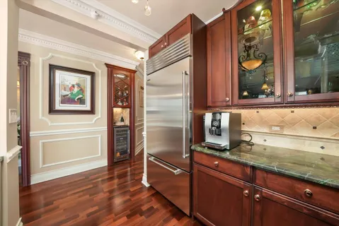 a kitchen with granite countertop stainless steel appliances a counter and a window