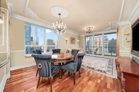 a view of a dining room with furniture wooden floor and chandelier