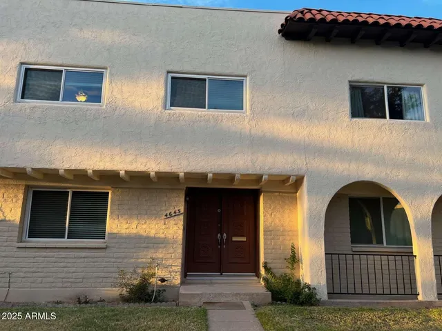 a kitchen with stainless steel appliances a dining table chairs and wooden floor