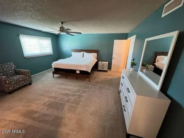 a bedroom with a bed and a dresser