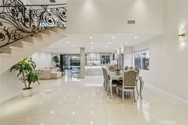 a large kitchen with stainless steel appliances kitchen island granite countertop a sink and cabinets