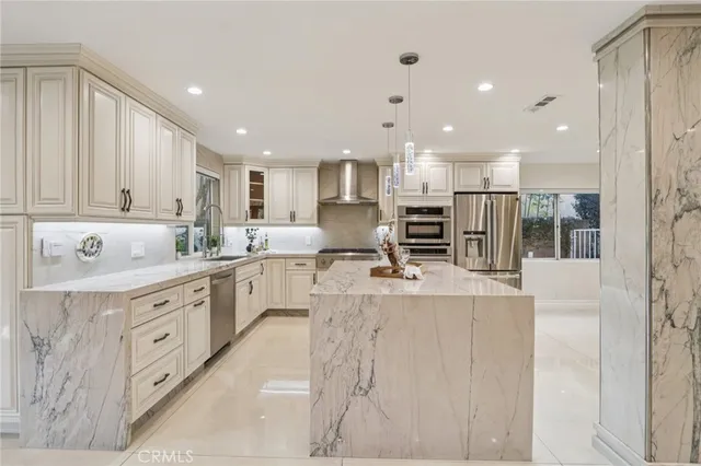 a spacious bedroom with a bed and a chandelier