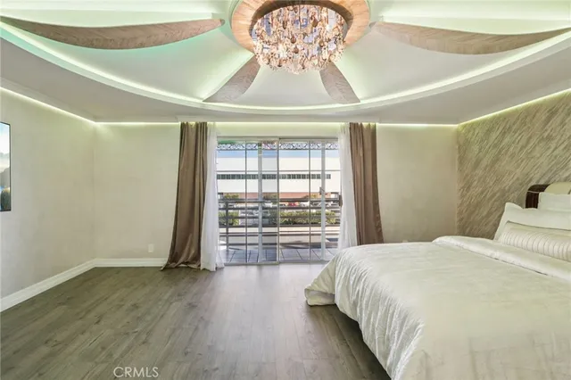 a bedroom with a bed and a chandelier