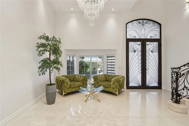a living room with furniture and a chandelier