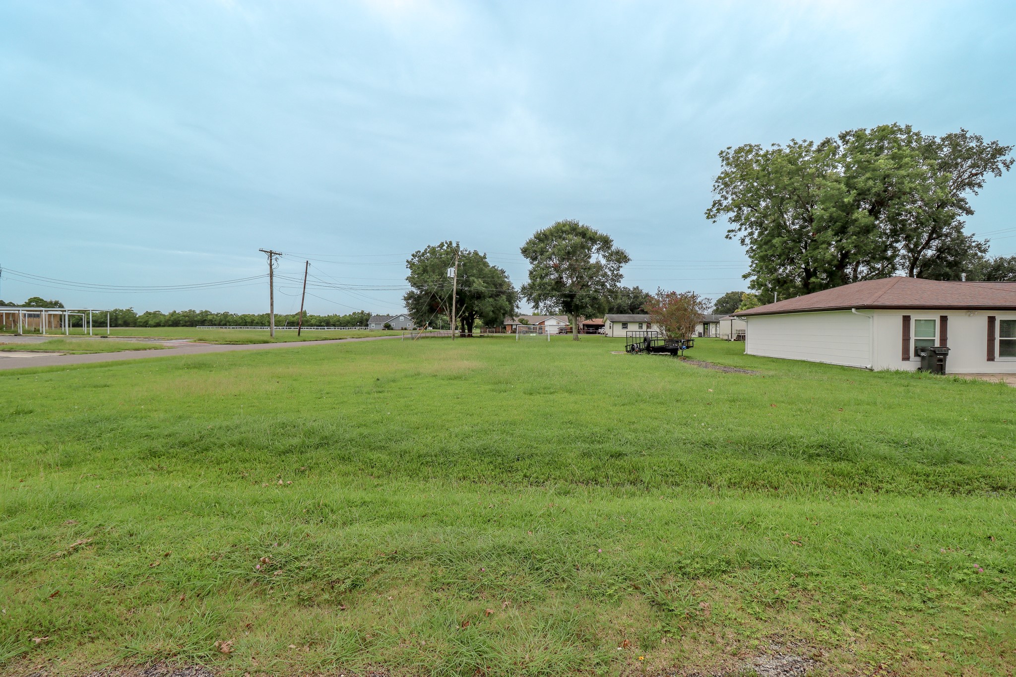 2895 Solomon Street Port Arthur, TX 77640 - Photo 6 of 7 a view of a house with a big yard and a large trees