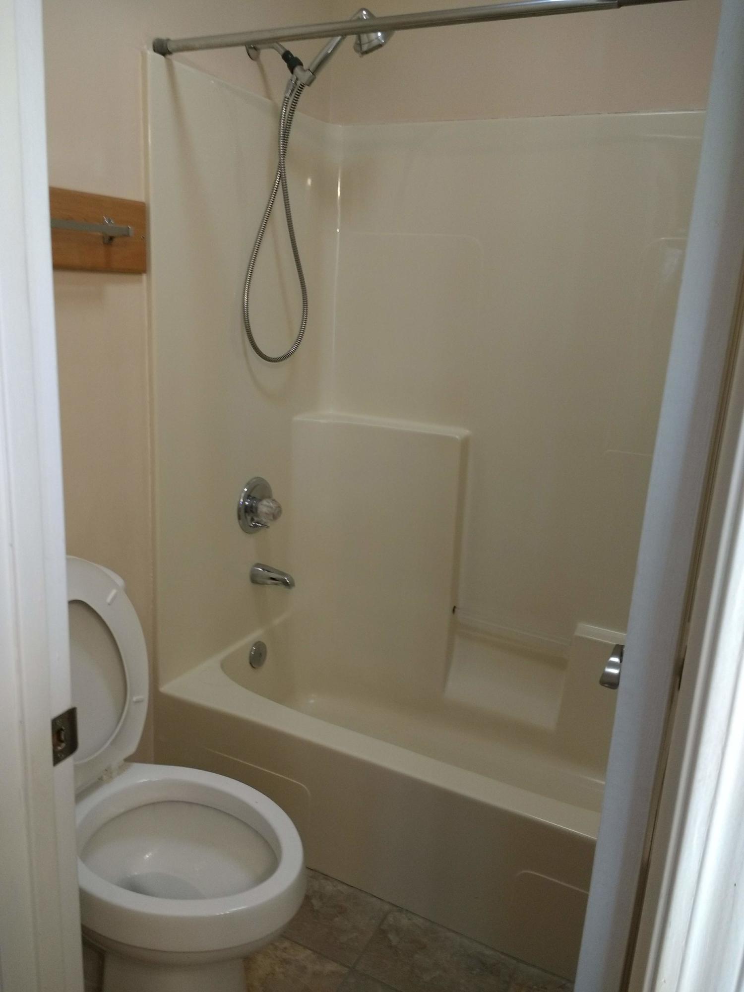 801 Cloverview Drive Crestview, FL 32536 - Photo 11 of 28 a bathroom with a granite countertop toilet and a shower