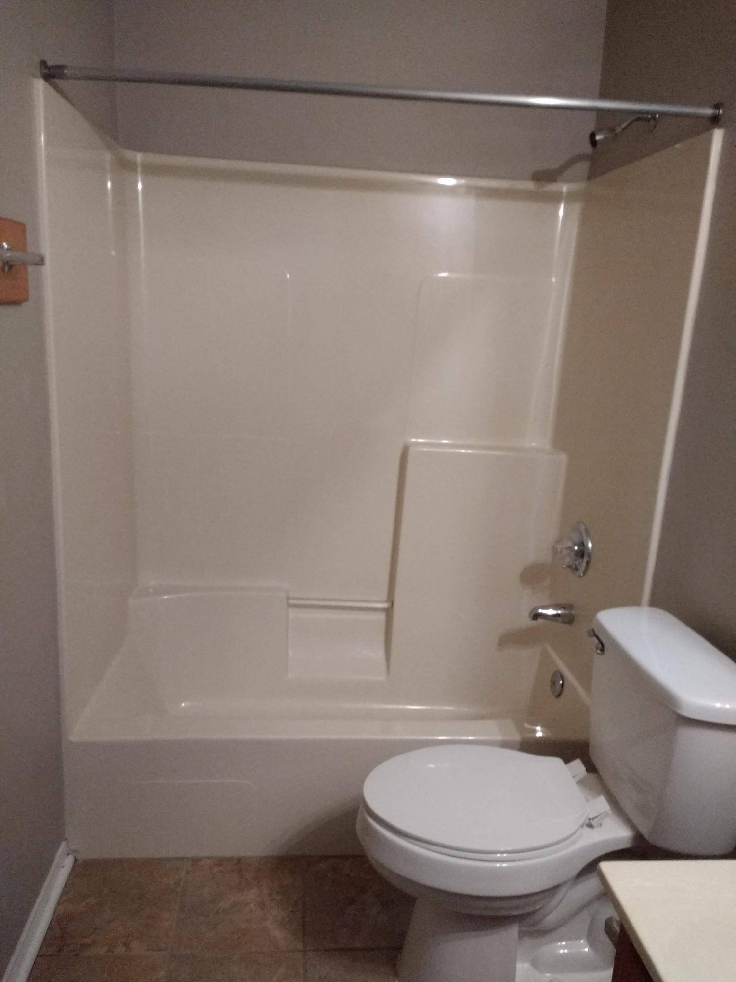 801 Cloverview Drive Crestview, FL 32536 - Photo 15 of 28 a white toilet sitting next to a bath tub