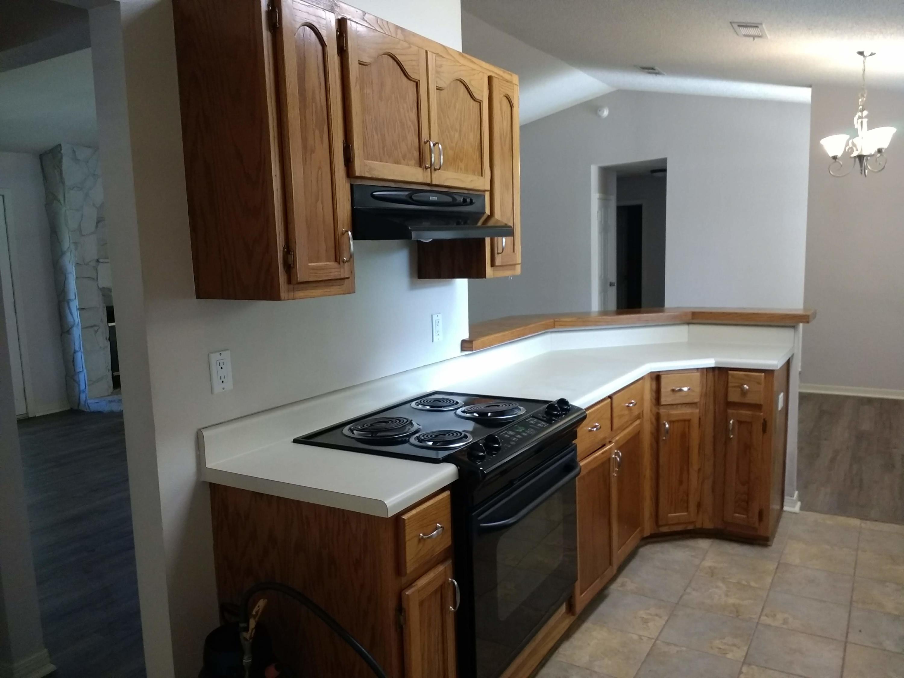 801 Cloverview Drive Crestview, FL 32536 - Photo 4 of 28 a kitchen with stainless steel appliances granite countertop a stove and a microwave