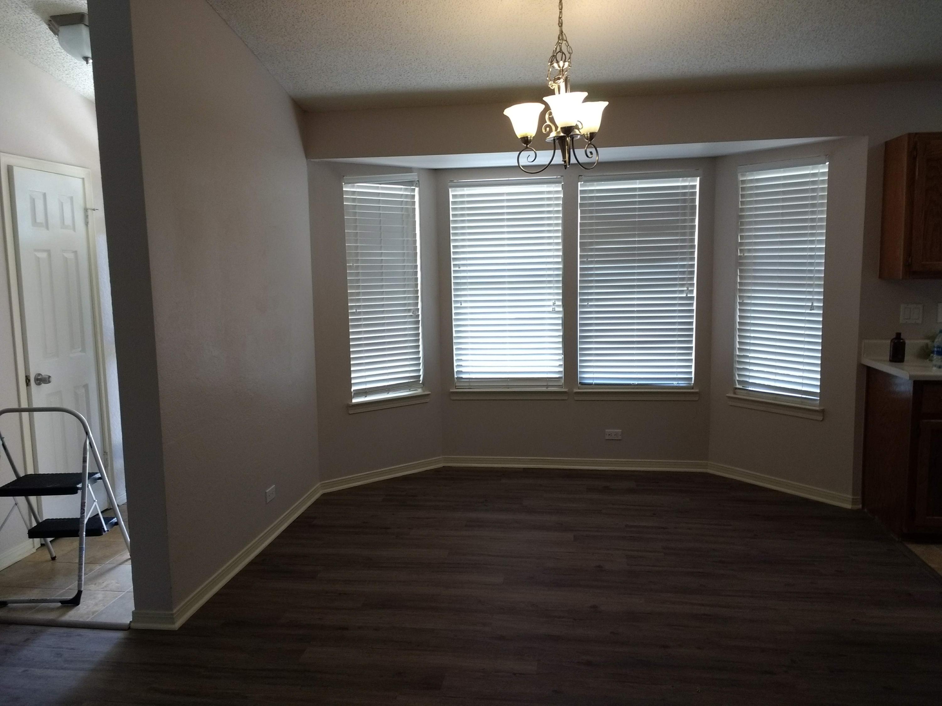 801 Cloverview Drive Crestview, FL 32536 - Photo 5 of 28 an empty room with wooden floor and windows