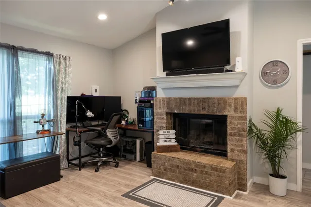 a living room with furniture a fireplace and a flat screen tv