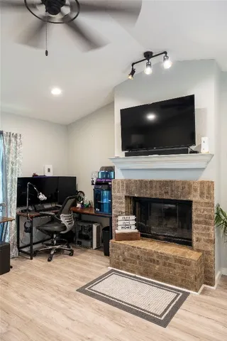 a living room with furniture a fireplace and a flat screen tv