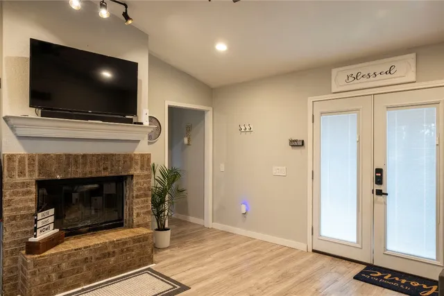 a living room with a fireplace and a flat screen tv
