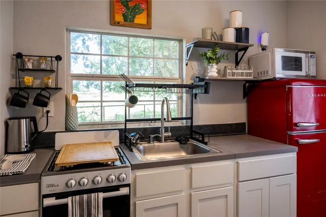 a kitchen with a stove and a white cabinets