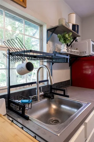 a kitchen with a stove a faucet and a cabinets