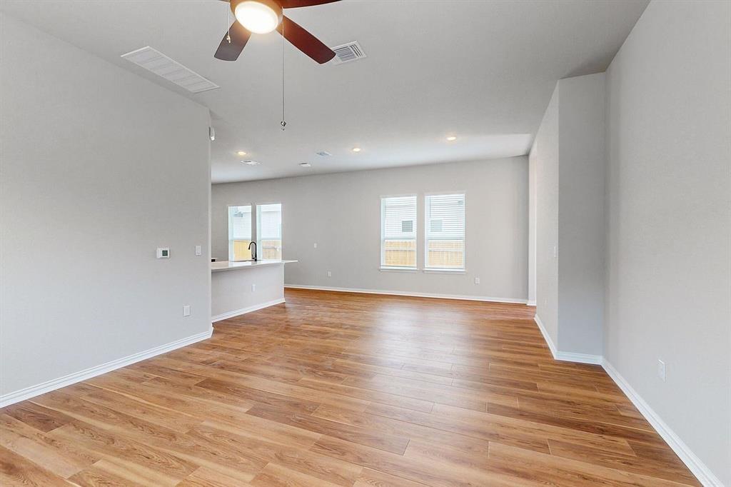 4907 Escape Rivera Drive Austin, TX 78747 - Photo 21 of 28 An inviting open-concept area boasts rich hardwood flooring, creating an ideal setting for gatherings.