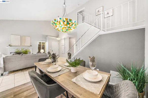 a dining room with furniture and a chandelier
