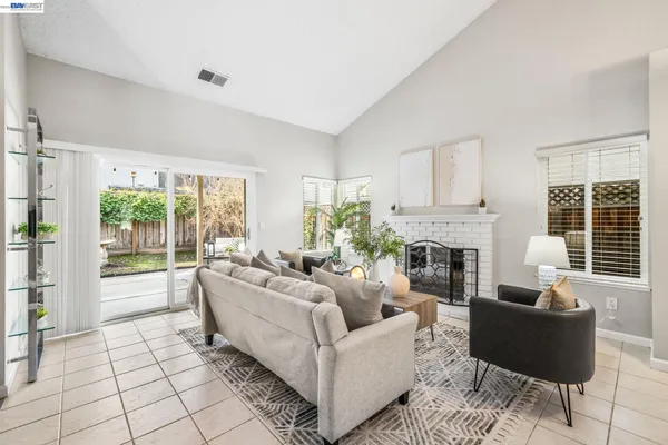a living room with furniture fireplace and a large window
