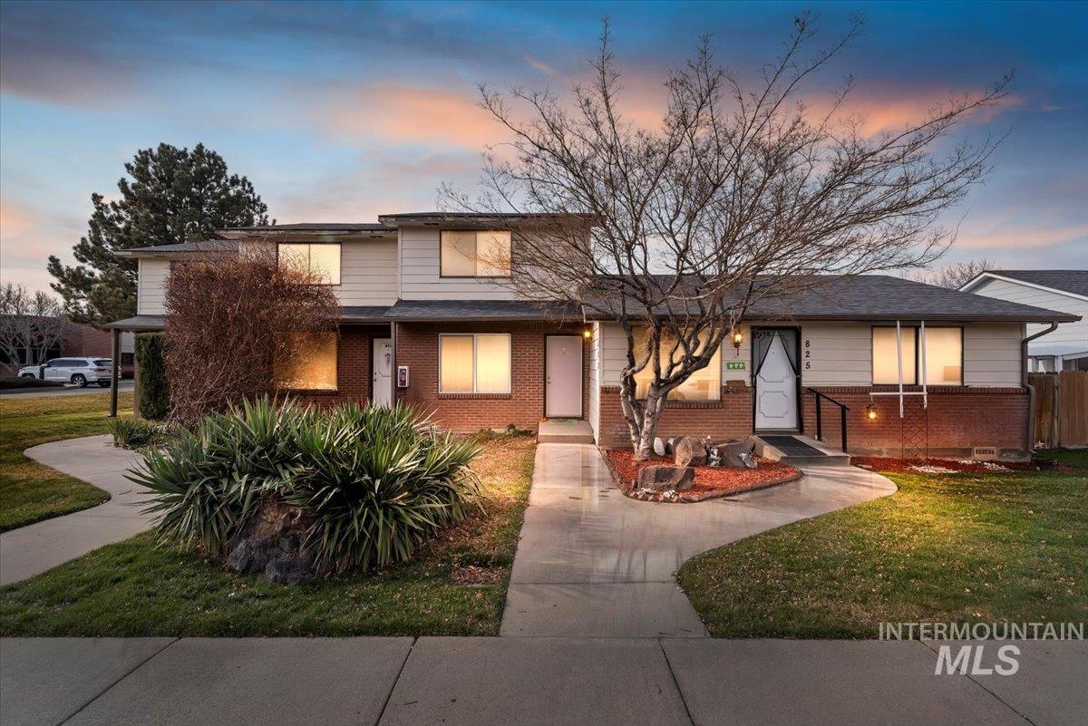 View of front of home with a front yard and brick siding