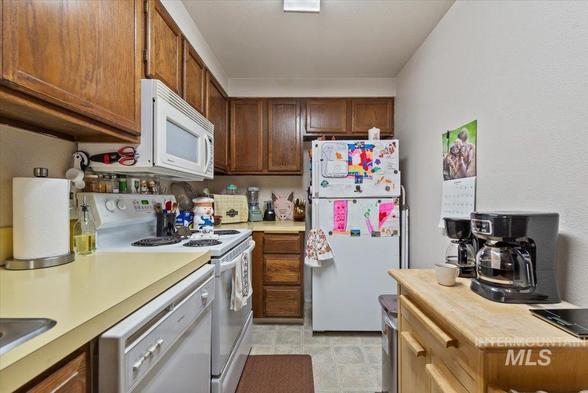 819 North Benjamin Lane Boise, ID 83704 - Photo 13 of 26 Kitchen with white appliances and light countertops