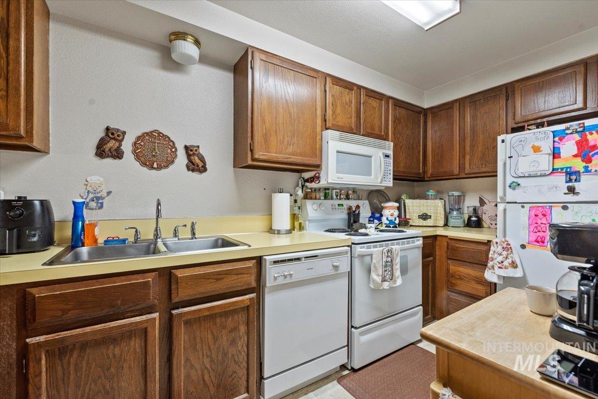 819 North Benjamin Lane Boise, ID 83704 - Photo 15 of 26 Kitchen featuring white appliances and light countertops