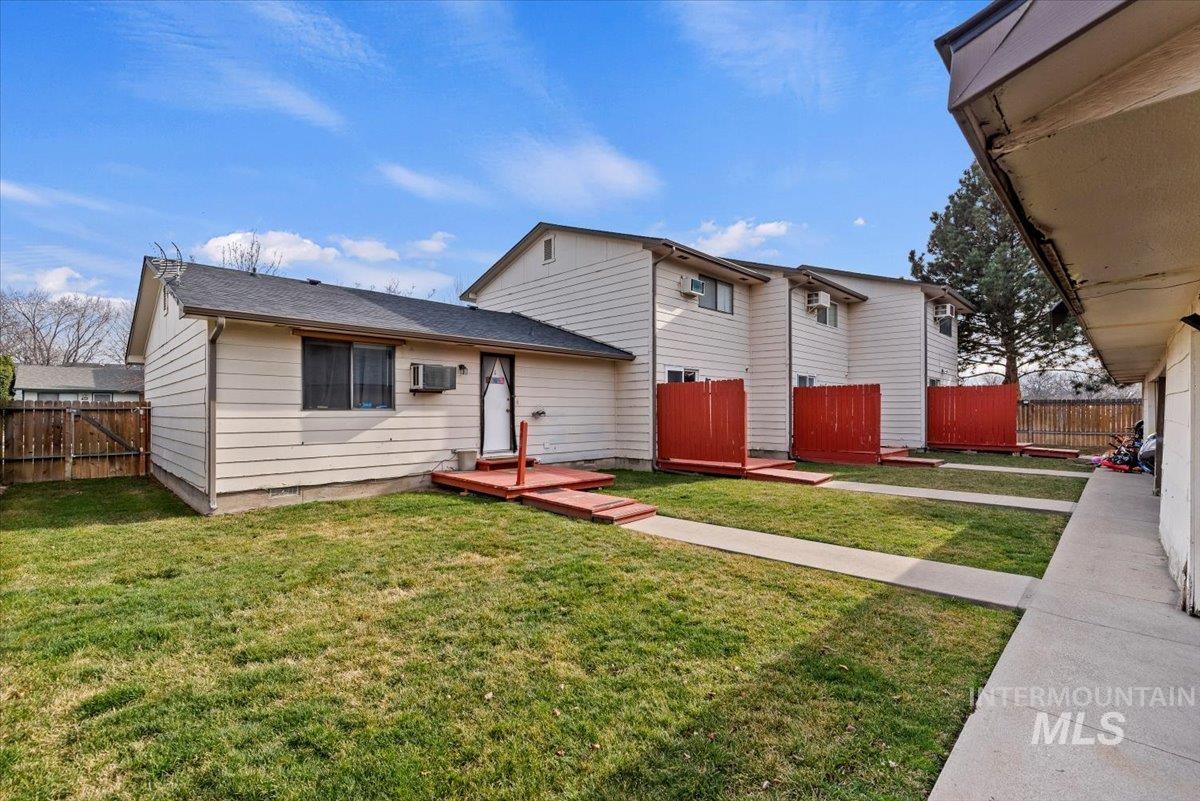 819 North Benjamin Lane Boise, ID 83704 - Photo 21 of 26 Rear view of house with a fenced backyard and roof with shingles