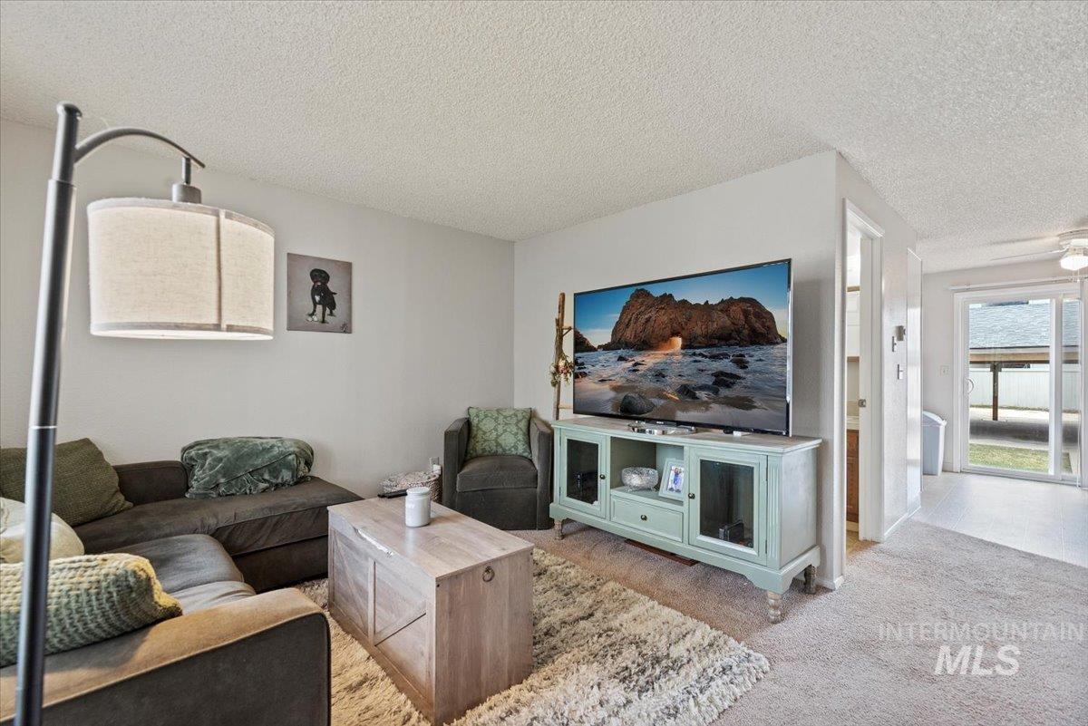 819 North Benjamin Lane Boise, ID 83704 - Photo 4 of 26 Living room featuring carpet floors and a textured ceiling