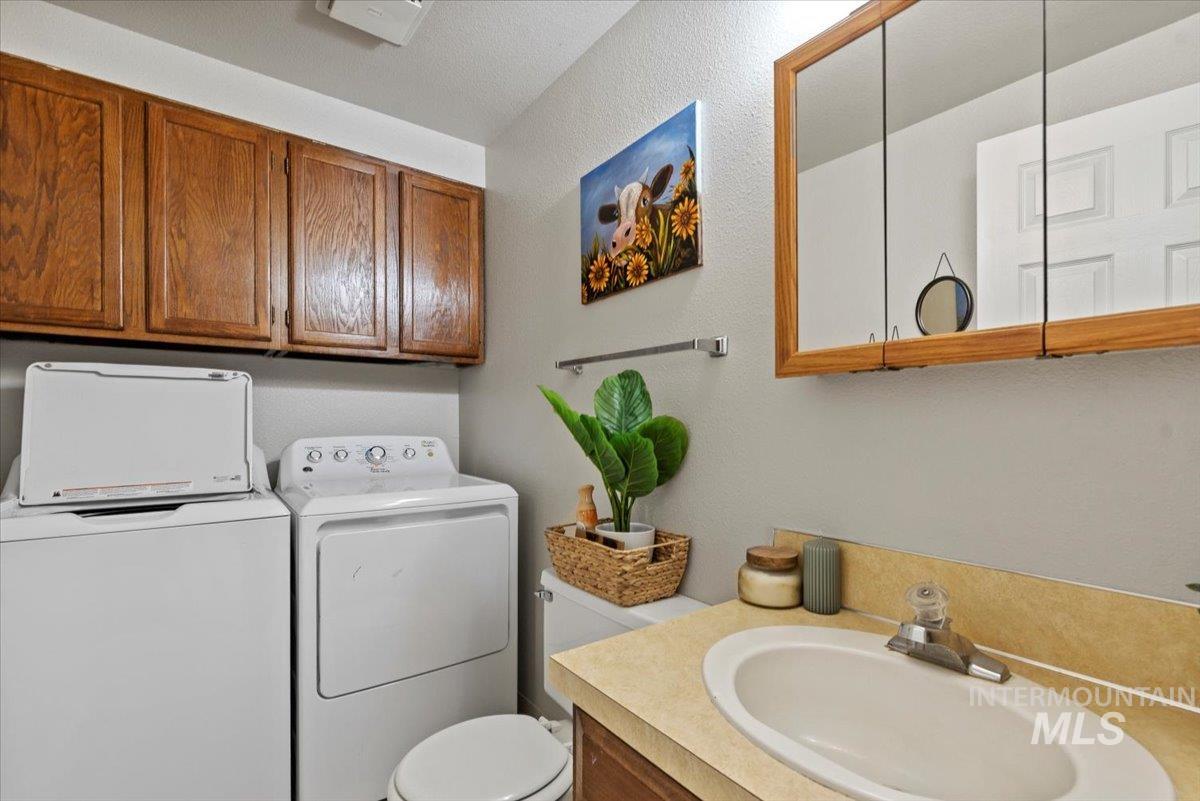 819 North Benjamin Lane Boise, ID 83704 - Photo 9 of 26 Bathroom featuring vanity, washing machine and dryer, and a textured wall