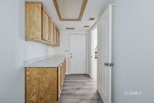 1213 Alysa Court Ridgecrest, CA 93555 - Photo 14 of 34 a view of a hallway with wooden floor and staircase