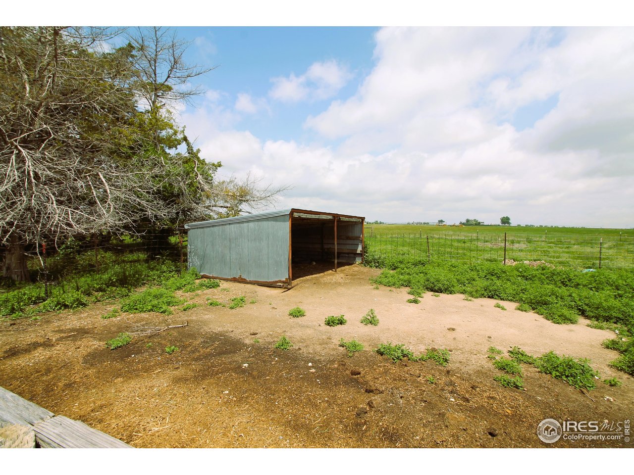 22354 County Road 41 Sterling, CO 80751 - Photo 22 of 40 a backyard of a house with a yard and garage