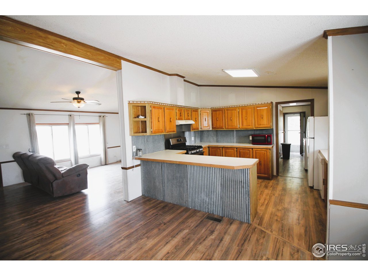 22354 County Road 41 Sterling, CO 80751 - Photo 25 of 40 a living room with furniture and a wooden floor
