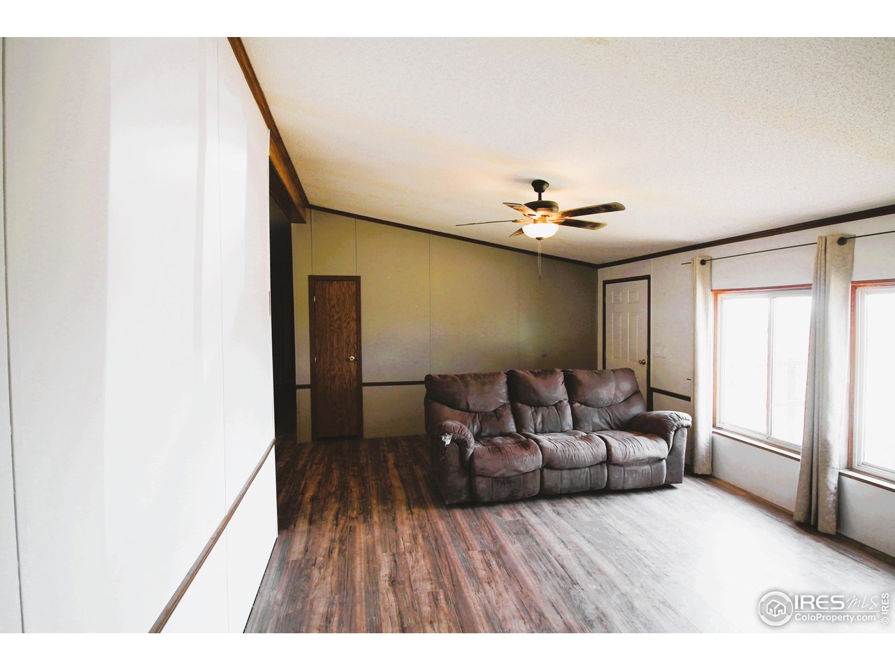 22354 County Road 41 Sterling, CO 80751 - Photo 27 of 40 a living room with furniture and a wooden floor