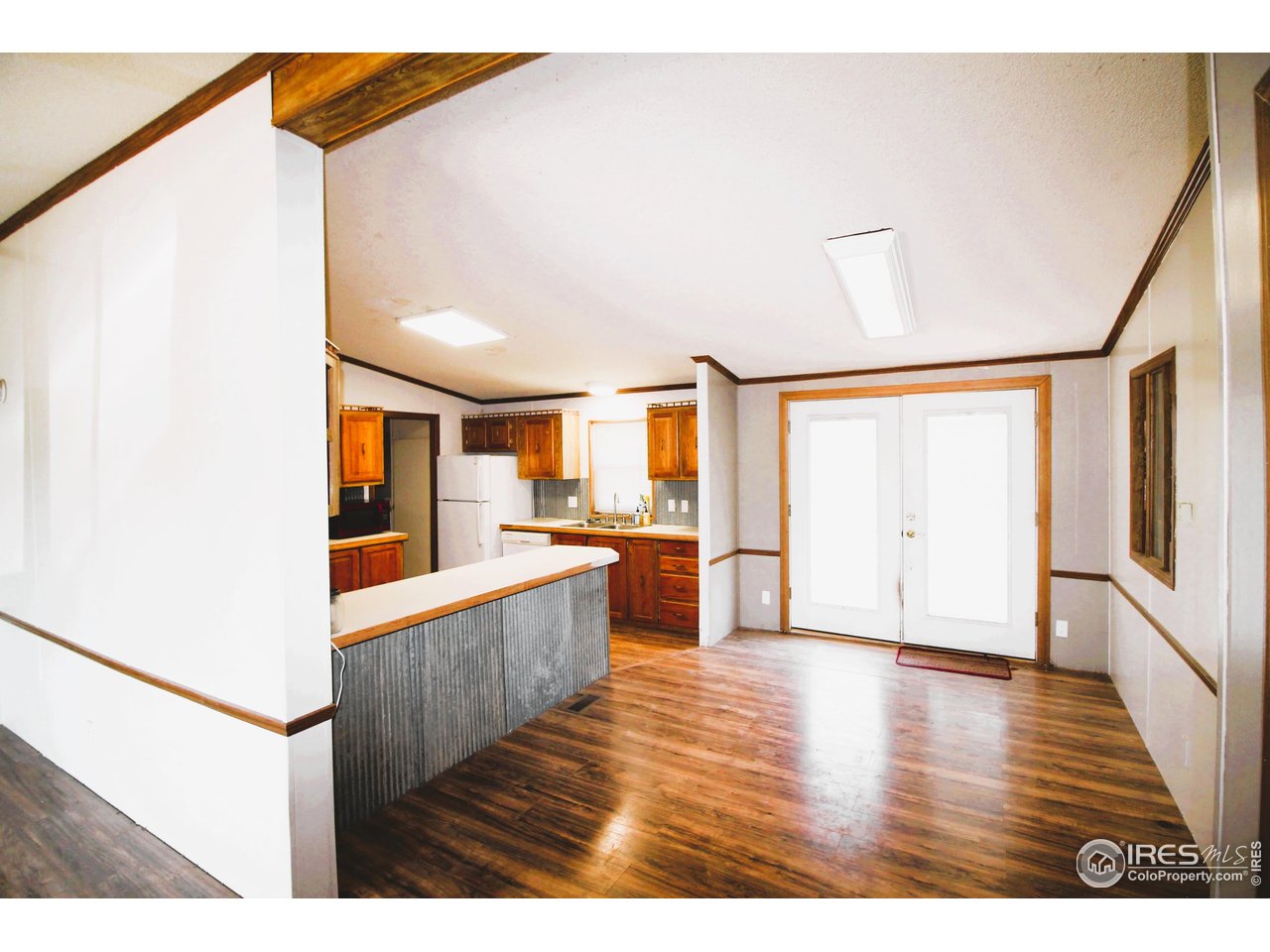 22354 County Road 41 Sterling, CO 80751 - Photo 30 of 40 a view interior of kitchen and hall with wooden floor