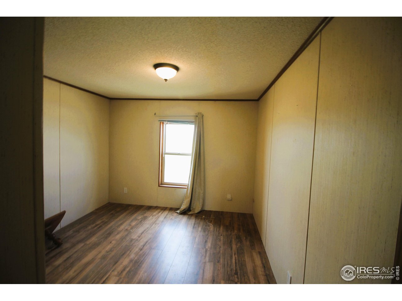 22354 County Road 41 Sterling, CO 80751 - Photo 38 of 40 a view of an empty room with wooden floor and a window