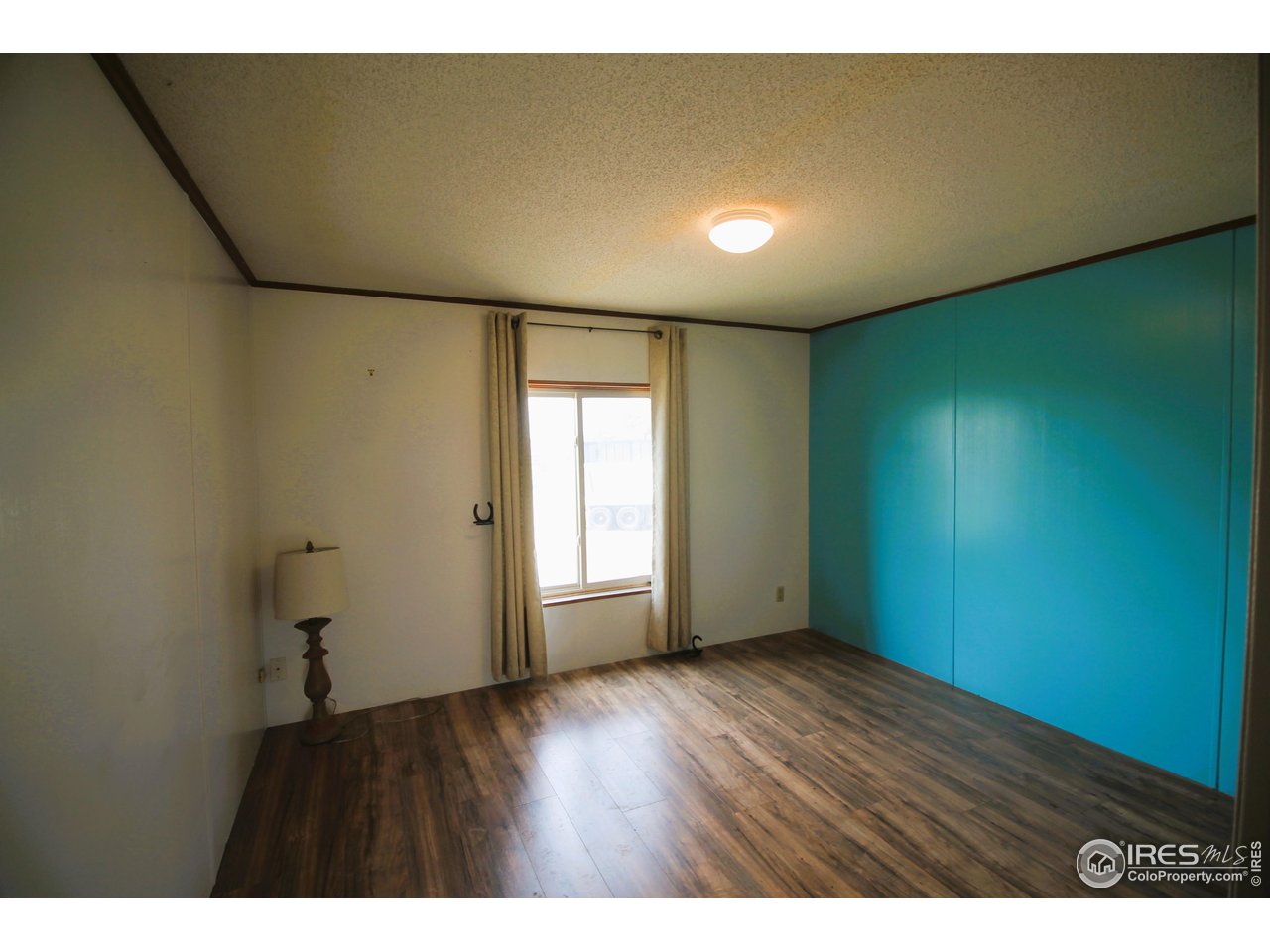 22354 County Road 41 Sterling, CO 80751 - Photo 39 of 40 a view of an empty room with wooden floor and a window