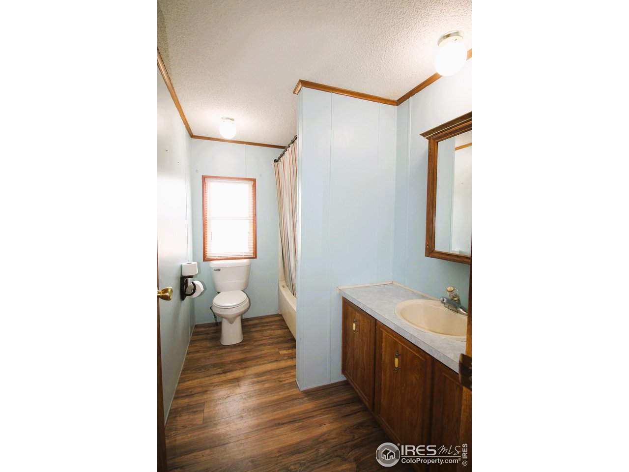 22354 County Road 41 Sterling, CO 80751 - Photo 40 of 40 a bathroom with a sink and a mirror