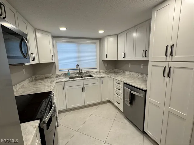 a kitchen with a sink stove and cabinets