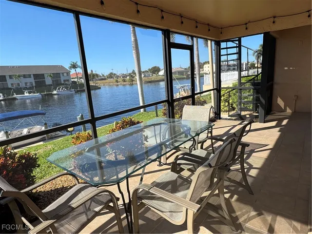a room with table chairs and wooden floor