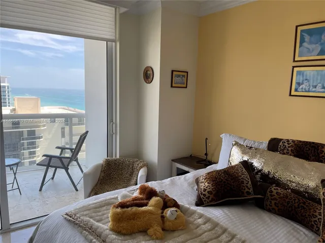 a bedroom with a bed and a chair