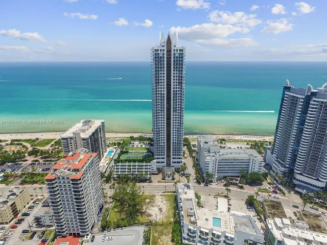 a view of a balcony with floor to ceiling windows yard