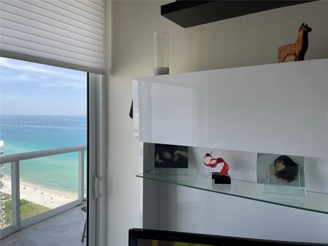 a utility room with mirror and a table