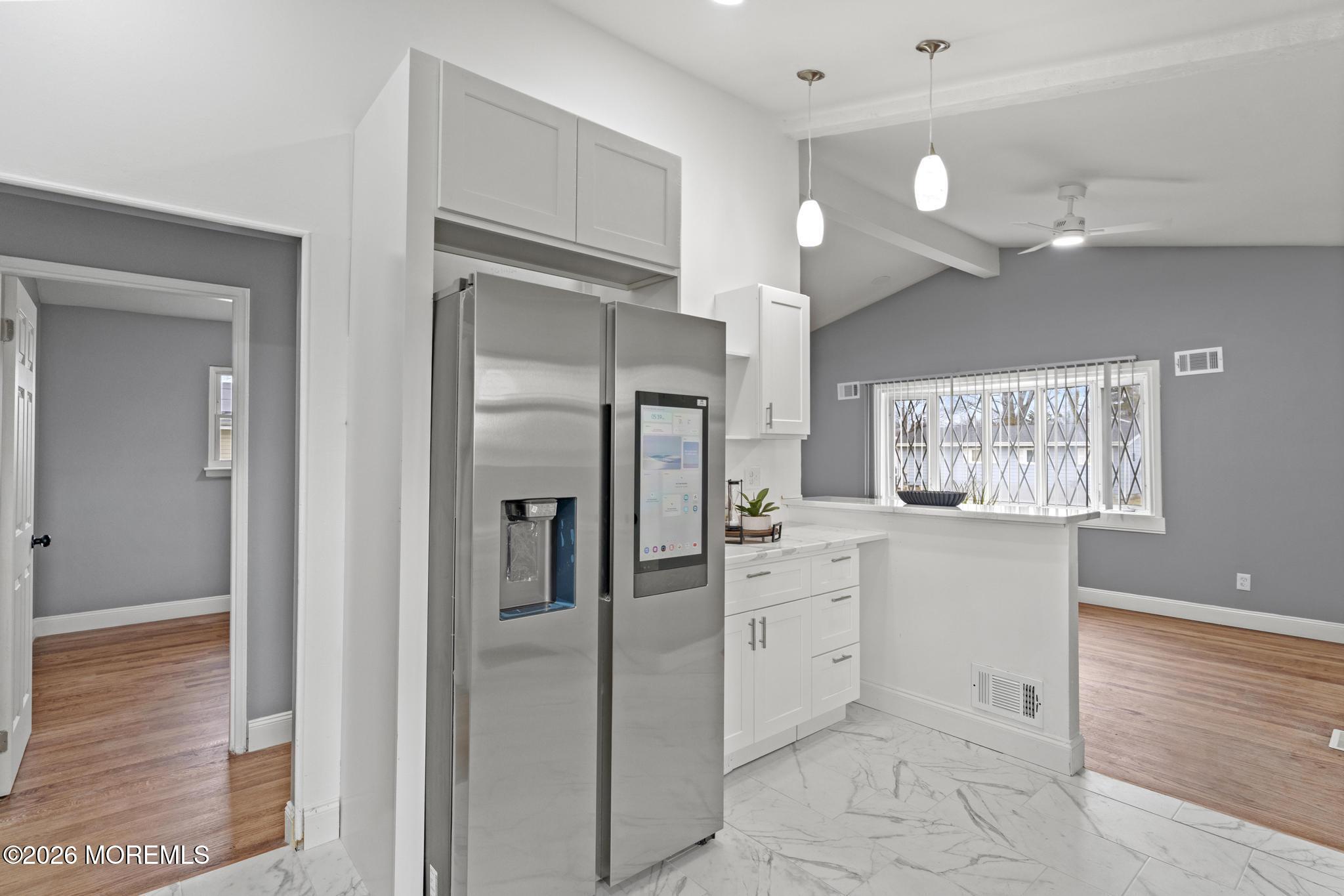 20 Kenneth Terrace Neptune Township, NJ 07753 - Photo 13 of 34 a kitchen with white cabinets and stainless steel appliances